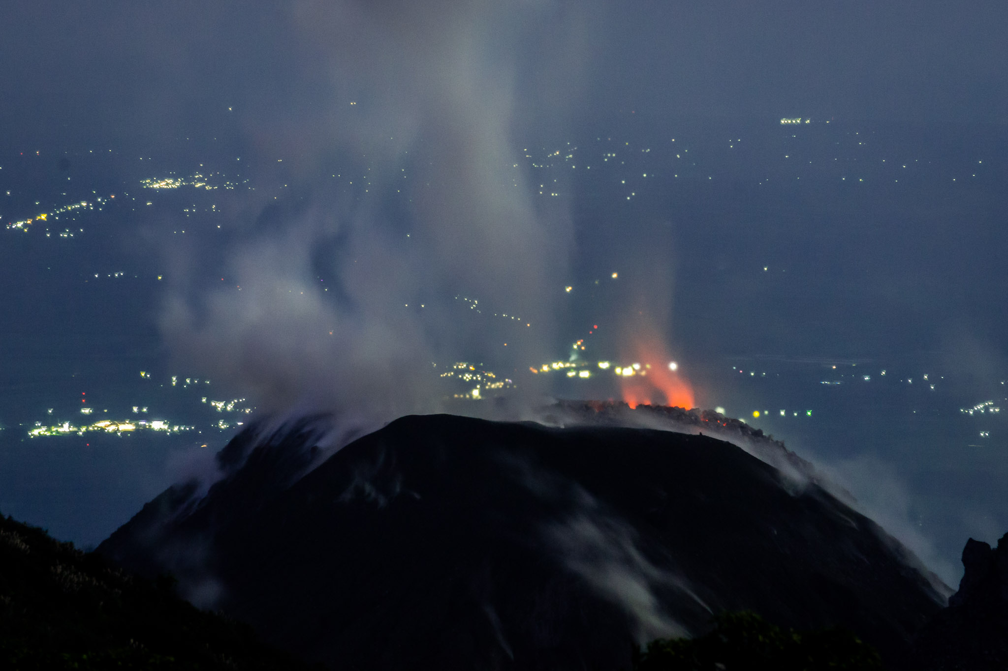 Glowing lava visible inside the vent between eruptions